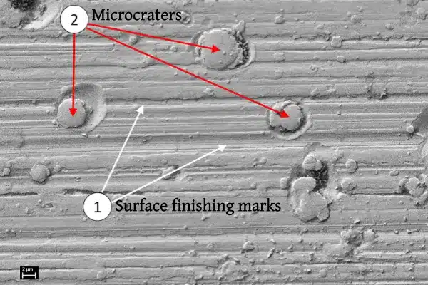 Microscope image showing electrical erosion microcraters on bearing steel surface