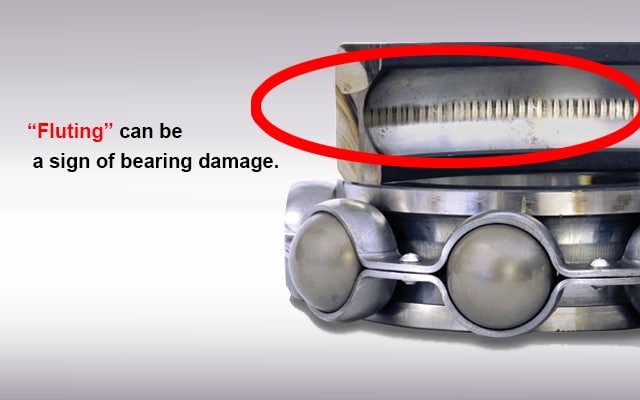 Motor bearing raceway displaying deep, evenly spaced washboard grooves characteristic of electrical fluting.