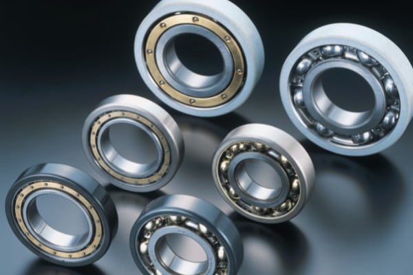A close-up 3D render showing different bearing insulation technologies applied to the outer ring of a deep groove ball bearing.